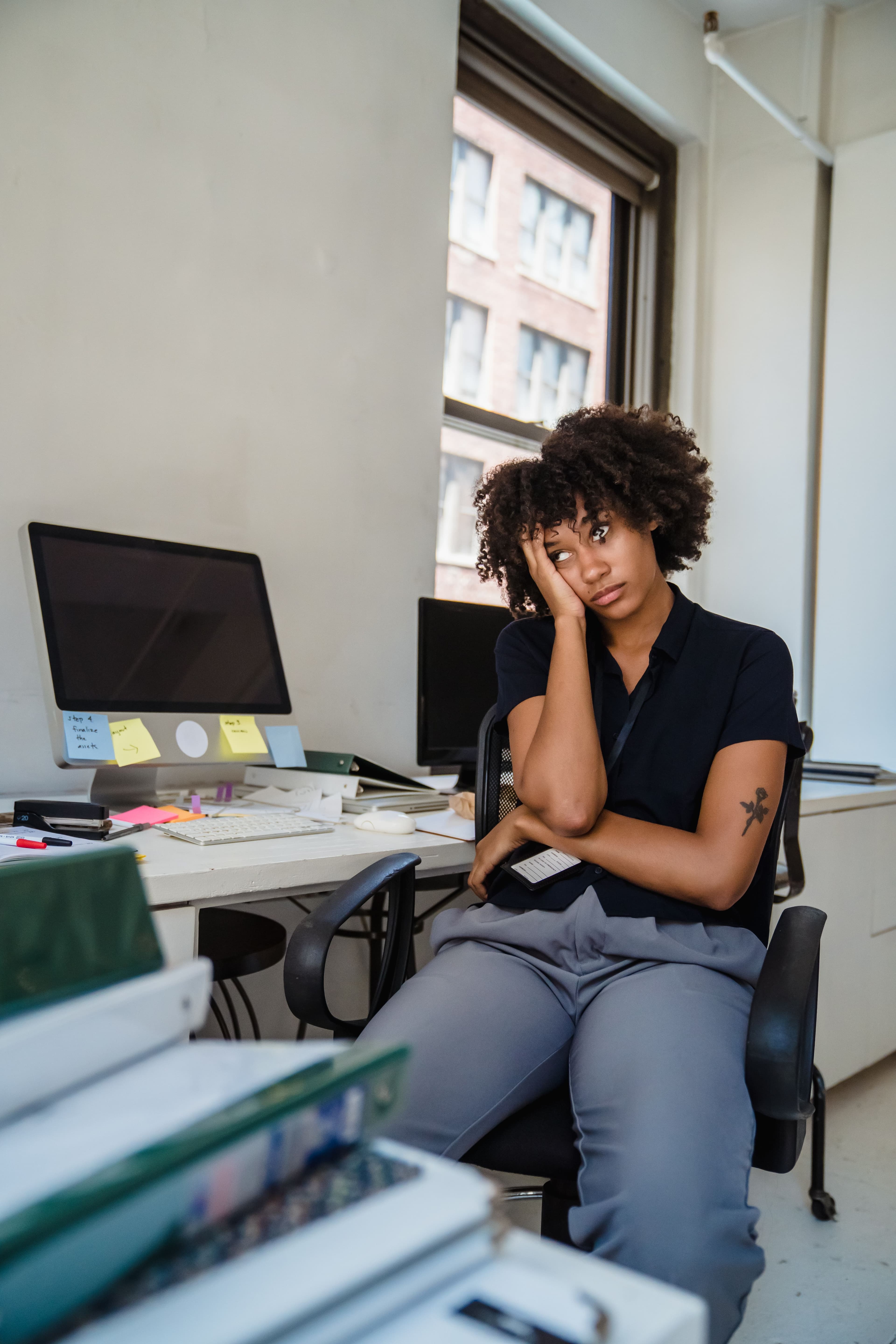 A stalled professional at their desk, capable but overlooked
